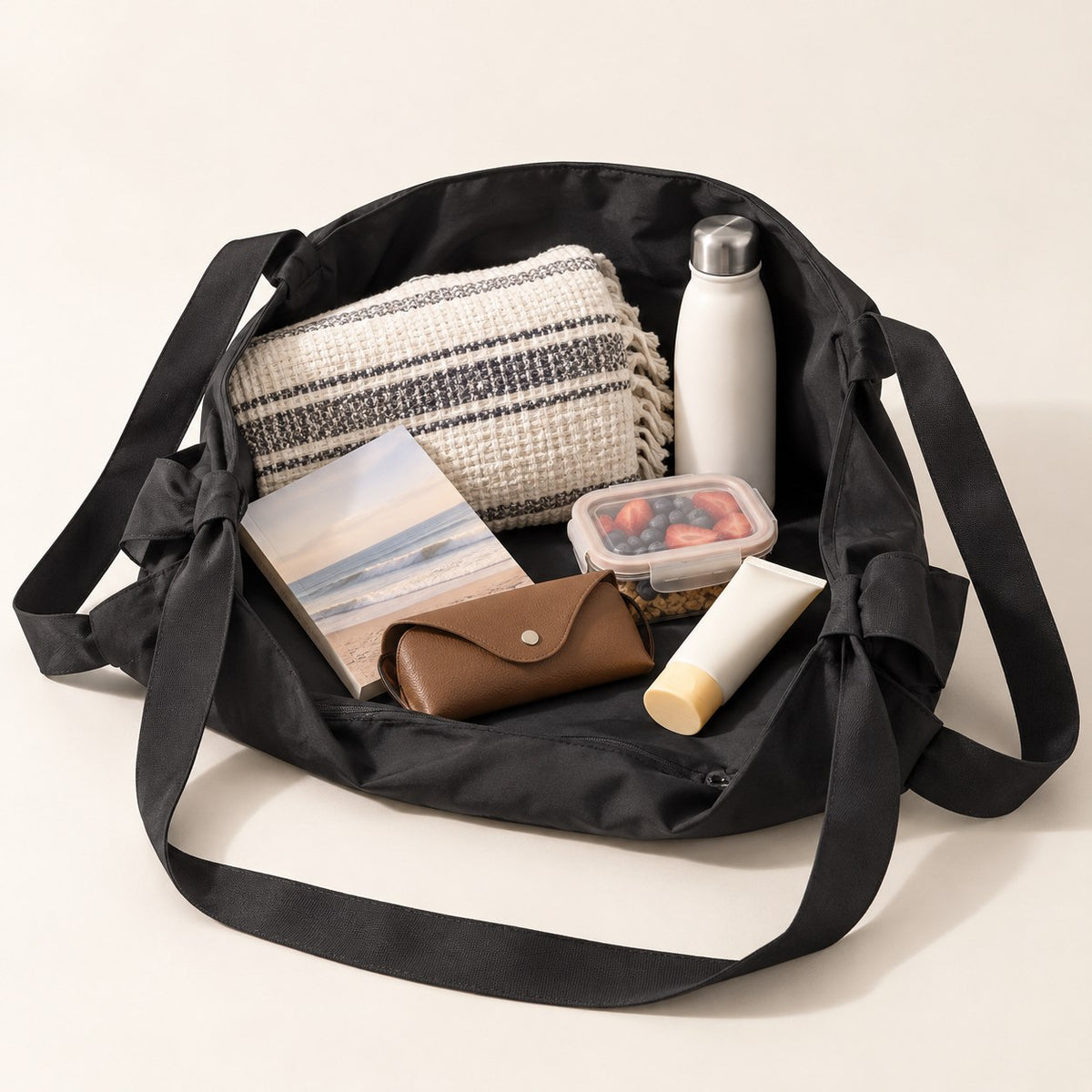 Open black tote holding day-out essentials